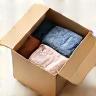 Open box with clothes inside, representing easy returns.